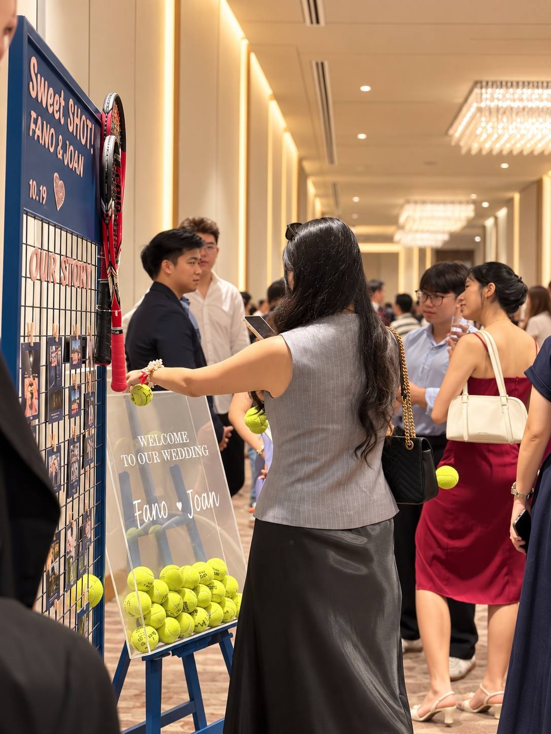 Guests gathering around the tennis-inspired photo display