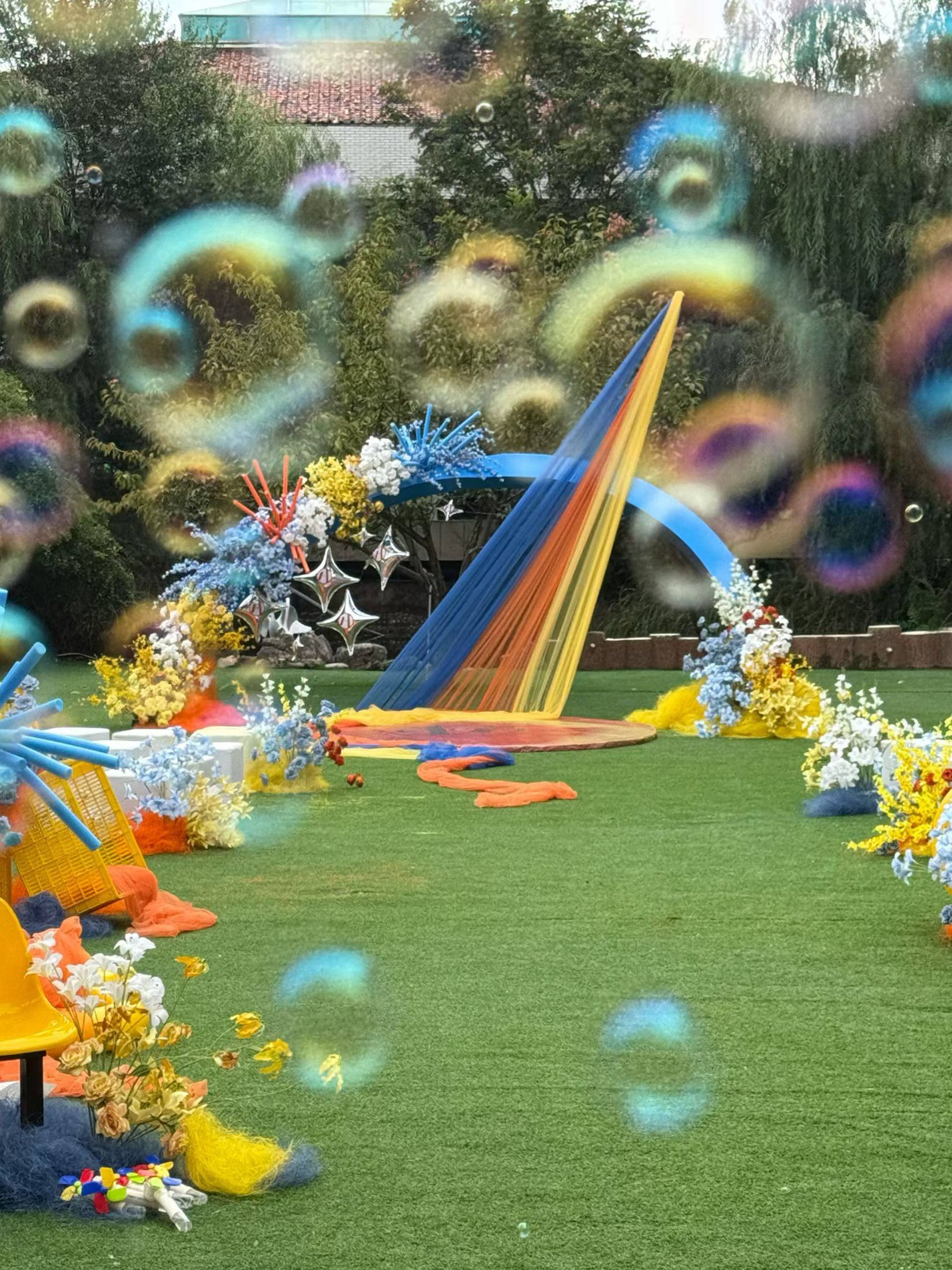 Bubbles floating above a colourful garden ceremony setting