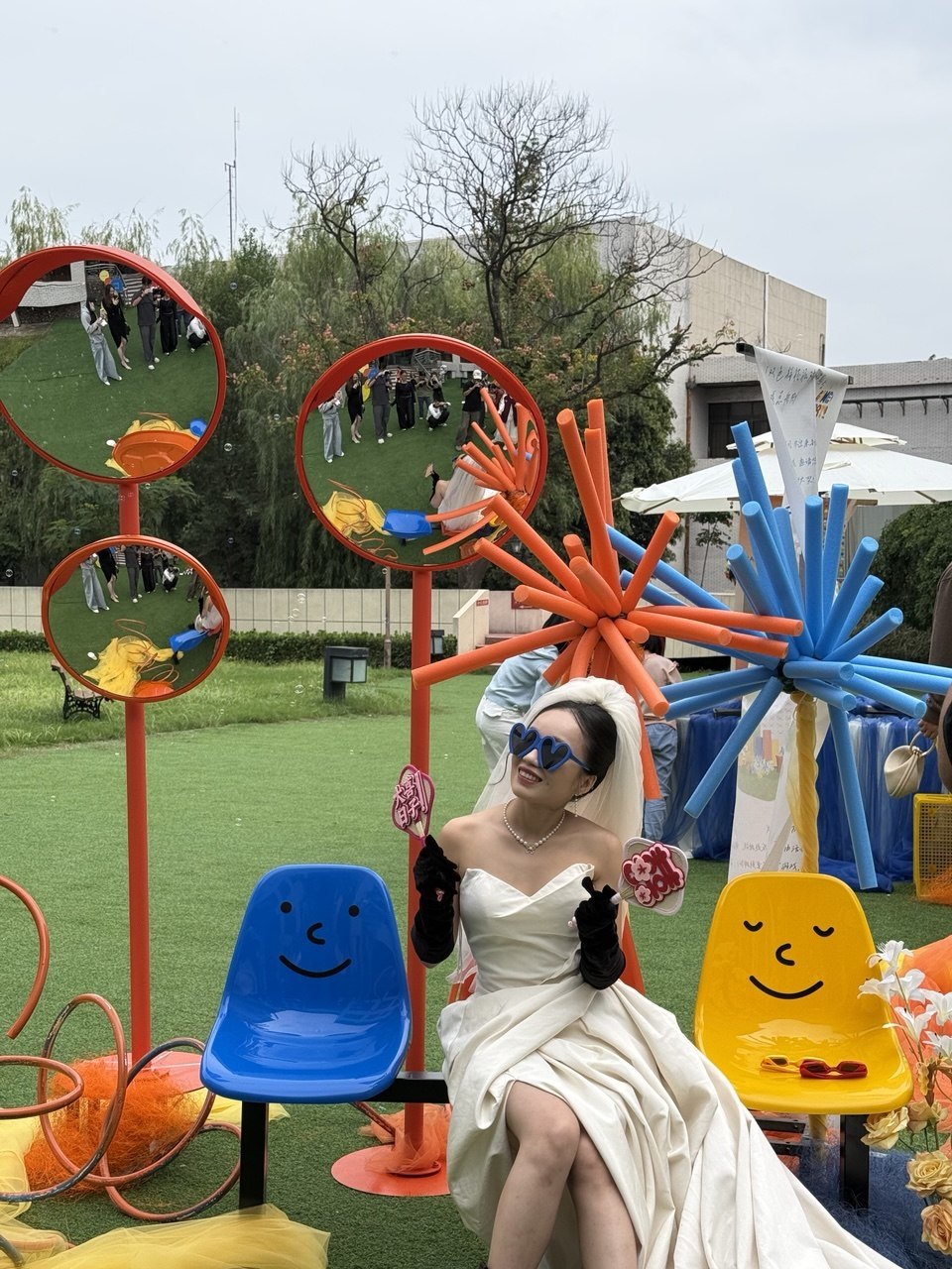 The bride beneath blue and orange starburst forms
