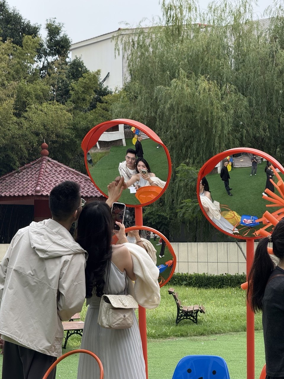 Guests photographing the couple through red circular frames