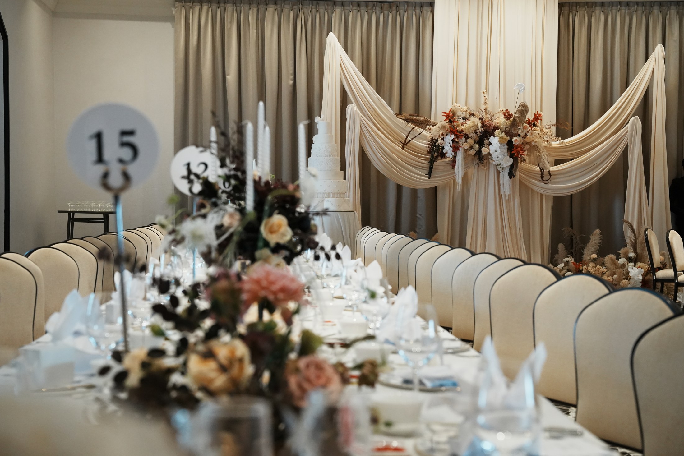 Ivory drapery and warm flowers framing the dining room